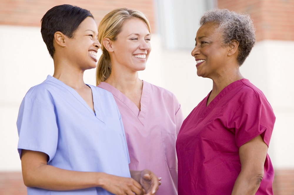 Three nurses in medical scrubs