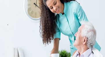 Woman in Medical Scrubs Speaking with Patient